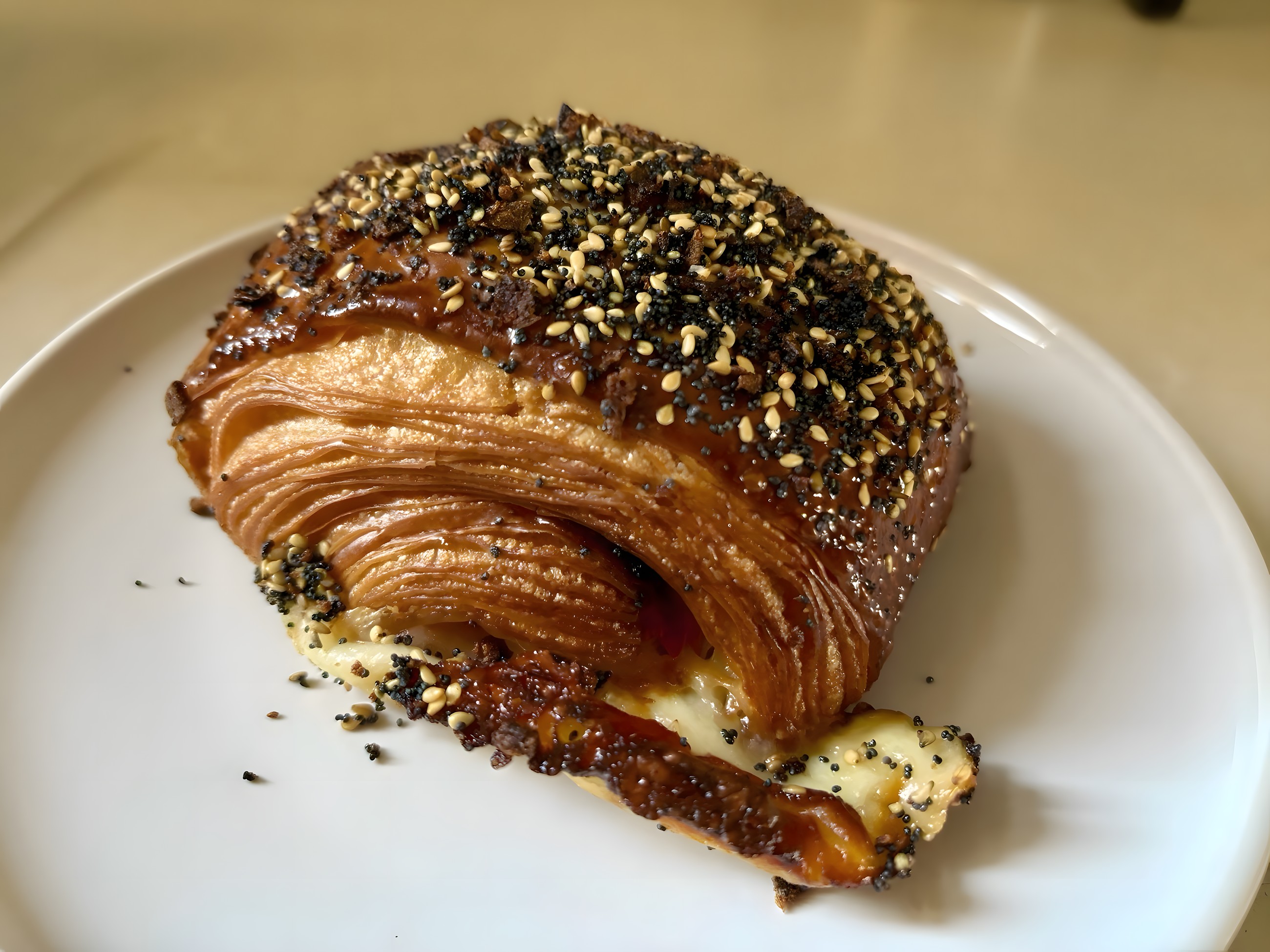 Seeded cheese croissant topped with poppy and sesame seeds